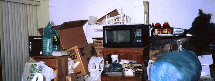 A cluttered living room in a hoarder house.
